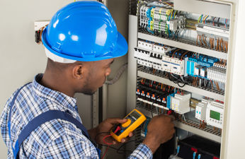 Electrician working on a power panel