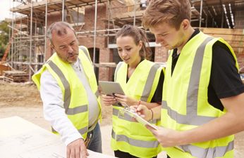 Group of young construction workers in a site
