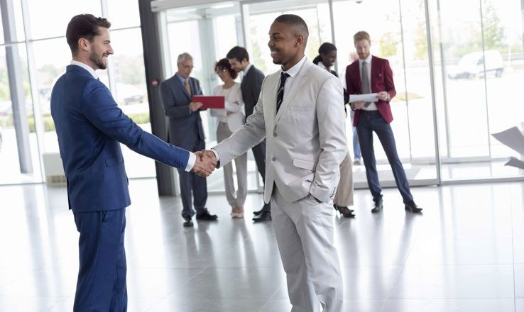 Two office workers shaking hands