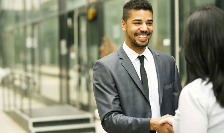 Young man shaking hands with an interviewer