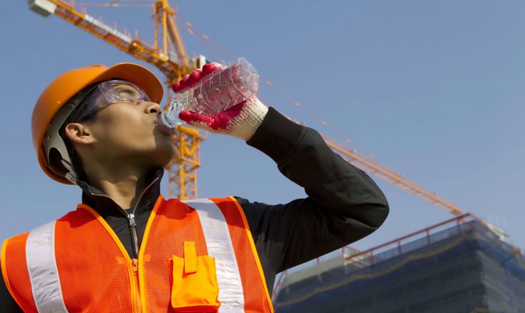 Construction worker drinking water