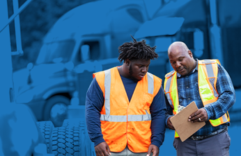 two men wearing hi-vis vests discussing their journeyman jobs