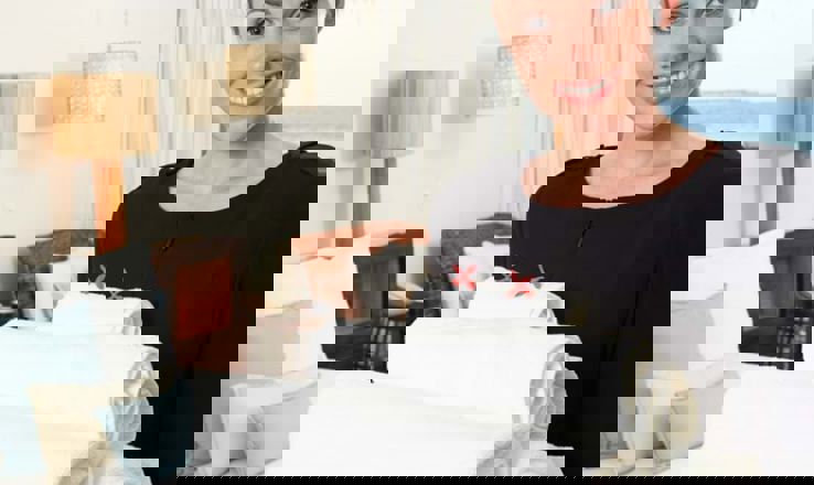 Housekeeper holding towels