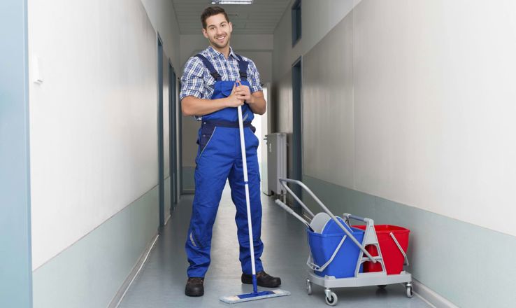 Maintenance man cleaning floors