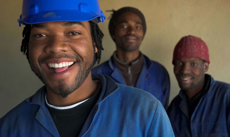 Group of happy men in hard hats