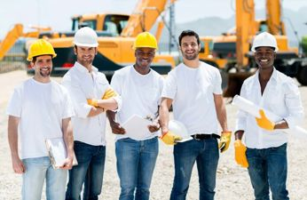 Group of happy construction workers on a job site